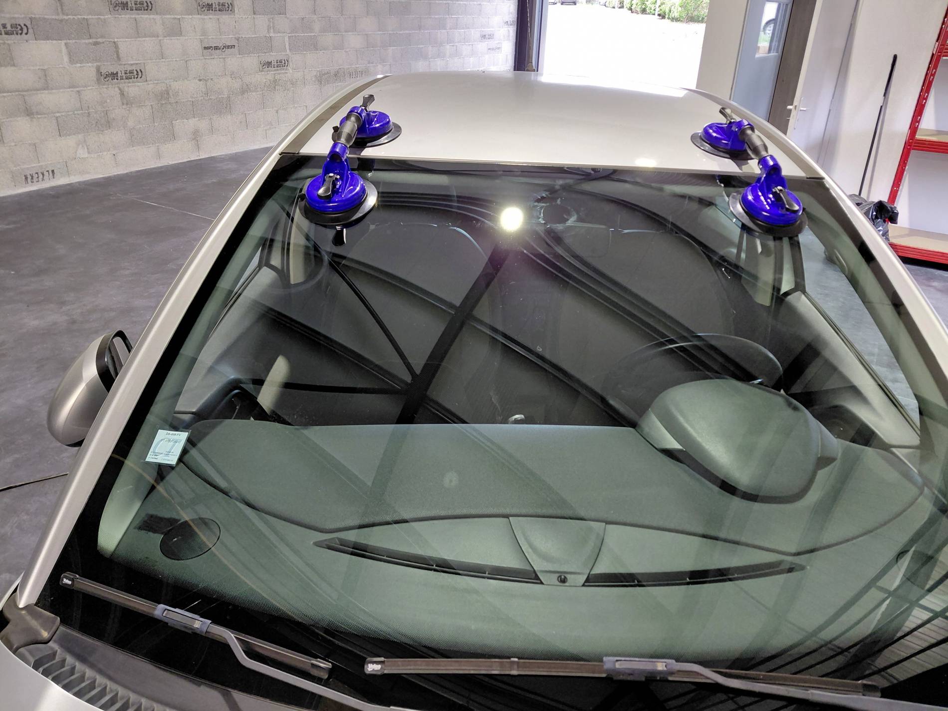 Remplacement d’un pare-brise automobile dans l’atelier